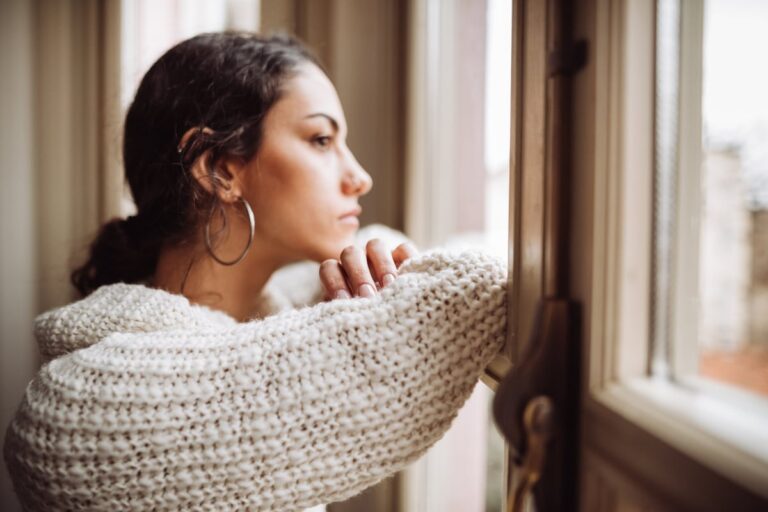 Stressed woman at window 0h7d5Gj