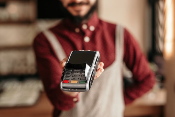 waiter holding credit card reader