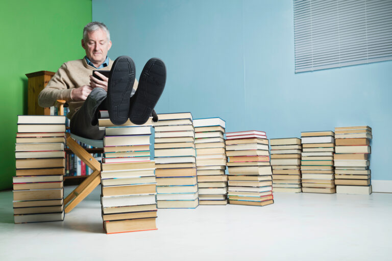 24 09 13 a person sitting and reading among stacks of books mf dload gettyimages 1132503689 1201x800 5b2df79