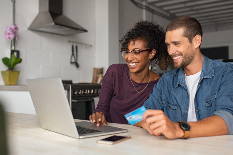 a couple making a payment on their computer