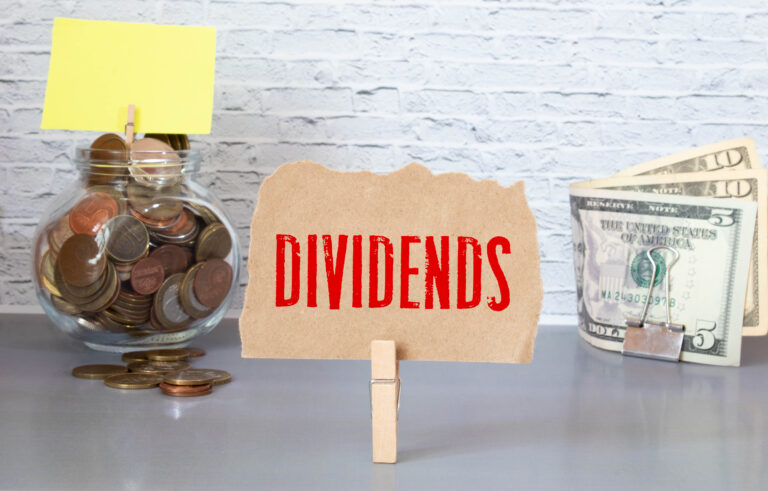 dividend sign with cash and coins