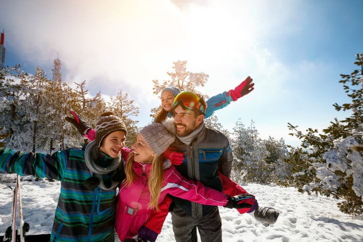 family skiing snowy mountain