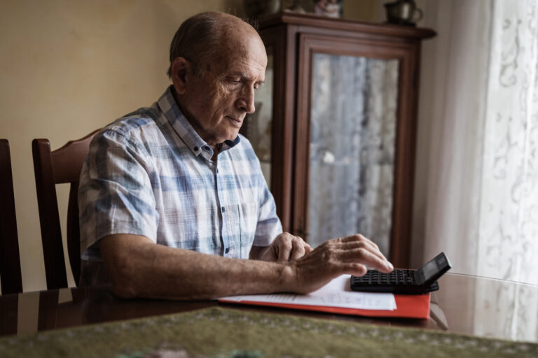 older man calculator gettyimages 1205262520