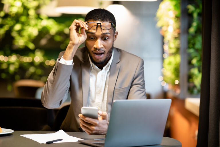 stock investor looking at their phone surprised