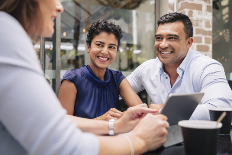 a couple smiling and talking with an advisor