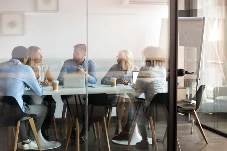 a group of people gathered around a table in an office