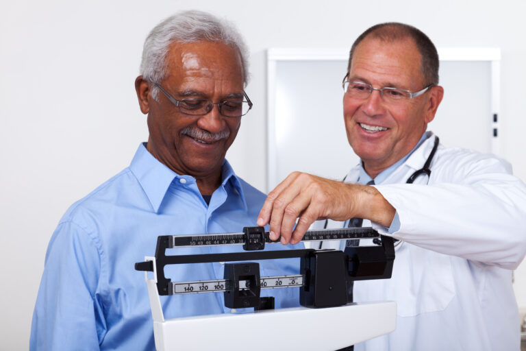 patient being weighed by a medical professional