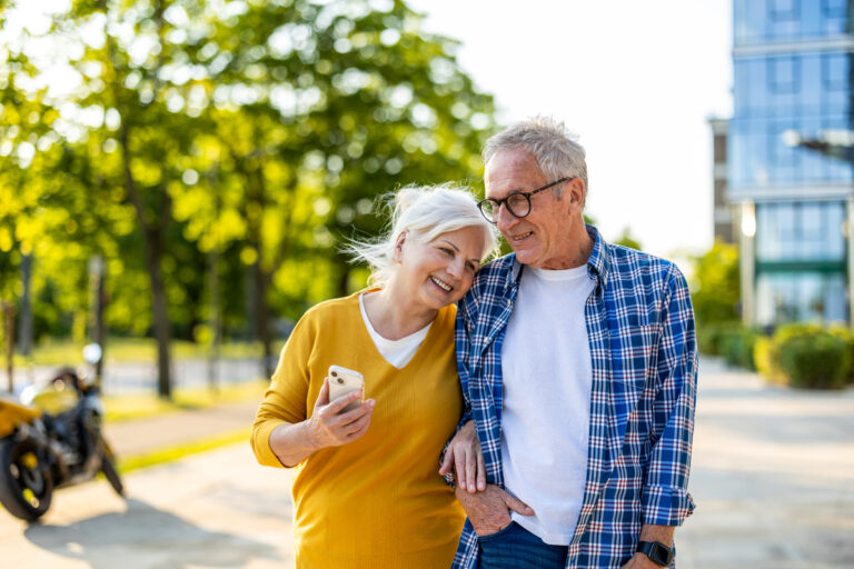 smiling couple walking down street together