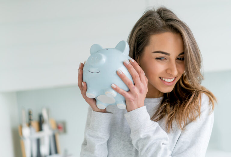 woman holding a piggy bank