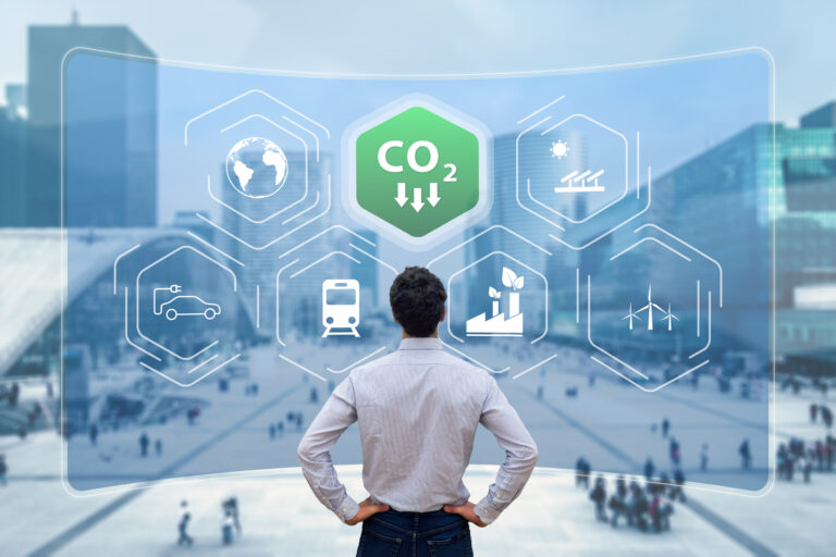 a person looking at icons representing falling carbon dioxide emissions