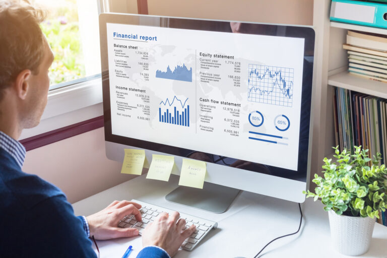 analyst analyzing stock charts on a computer screen