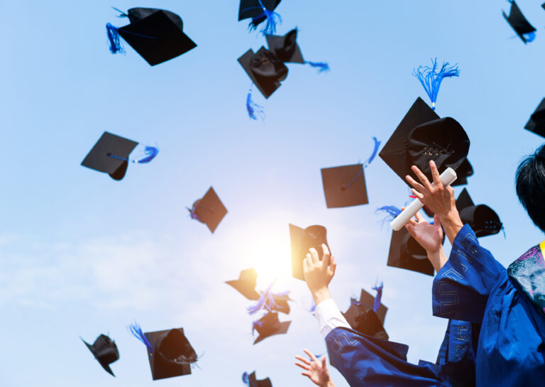 graduation caps flying into the air after being tossed